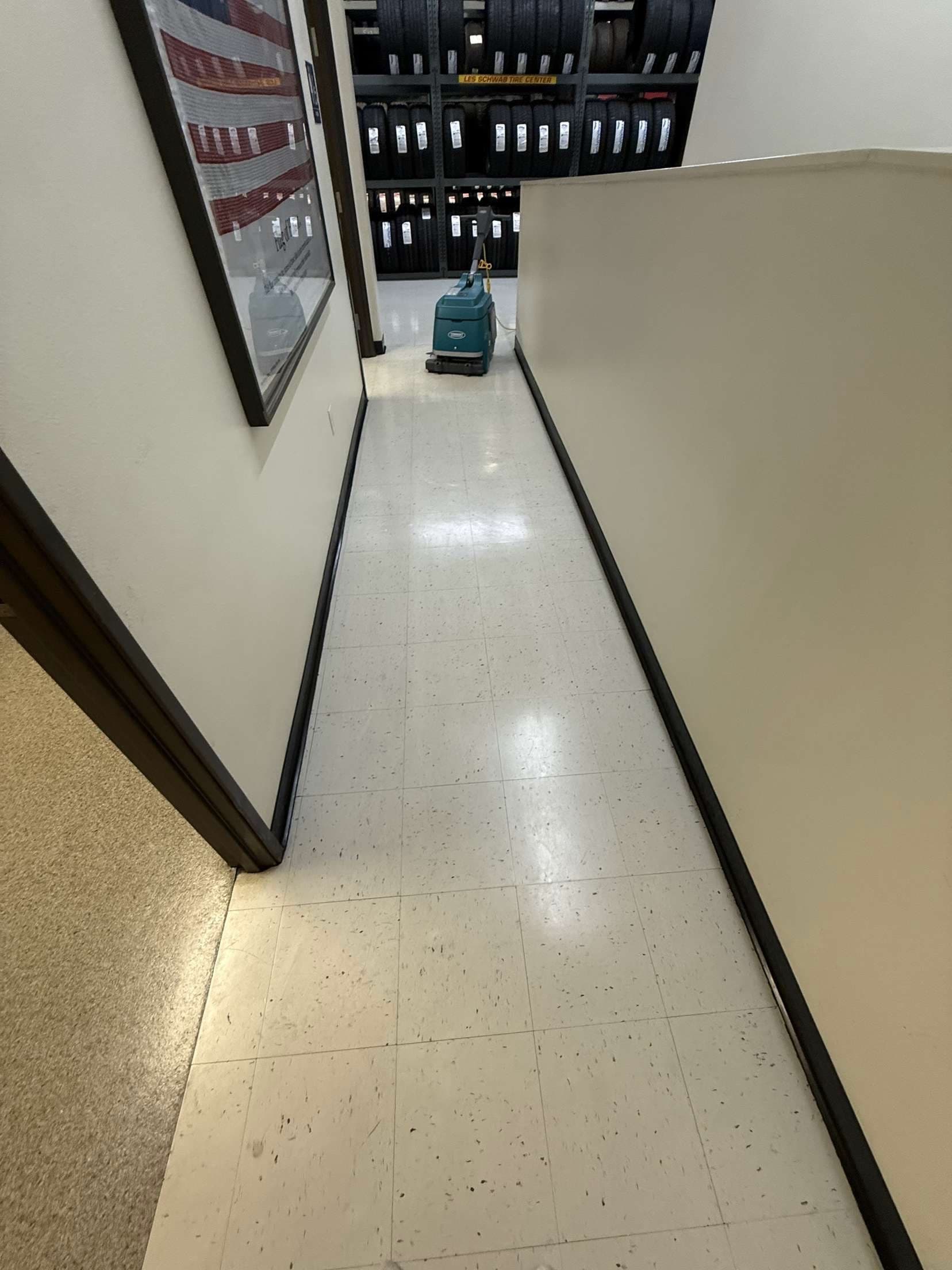Professional Tennant floor scrubber in commercial corridor